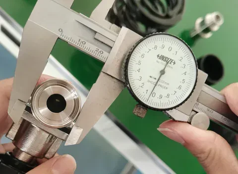 A sanitary ferrule measured with a dial caliper at Joneng
