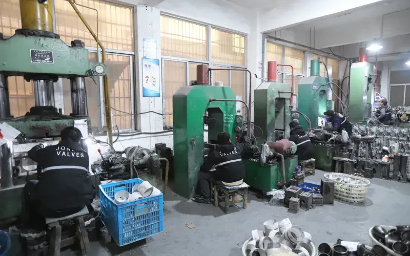 Hydraulic presses forming stainless steel pipe fittings at Joneng